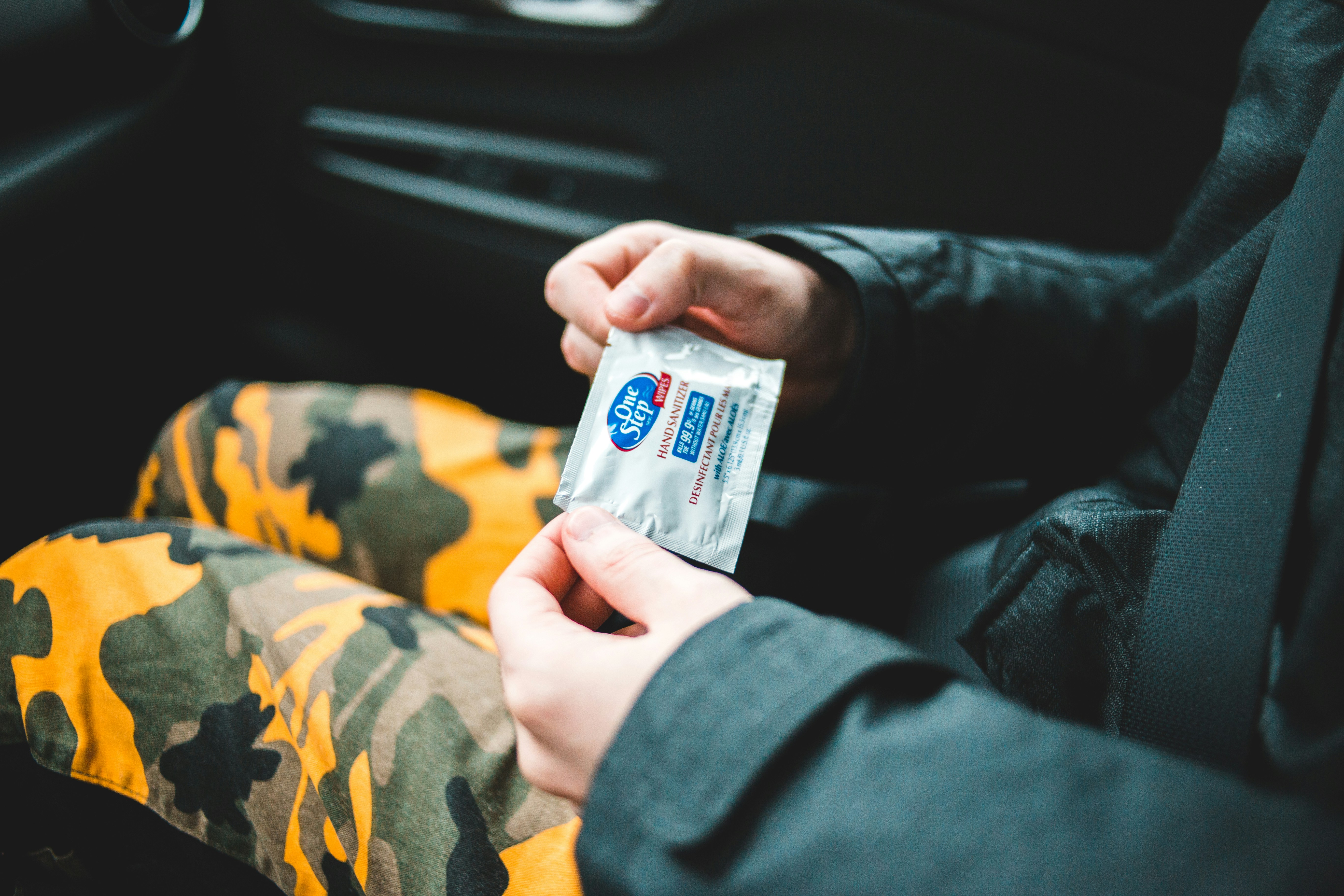 person holding white and blue plastic pack